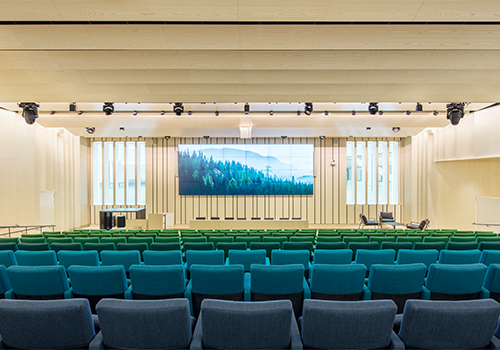 Auditorium cladded with wood panelling in birch