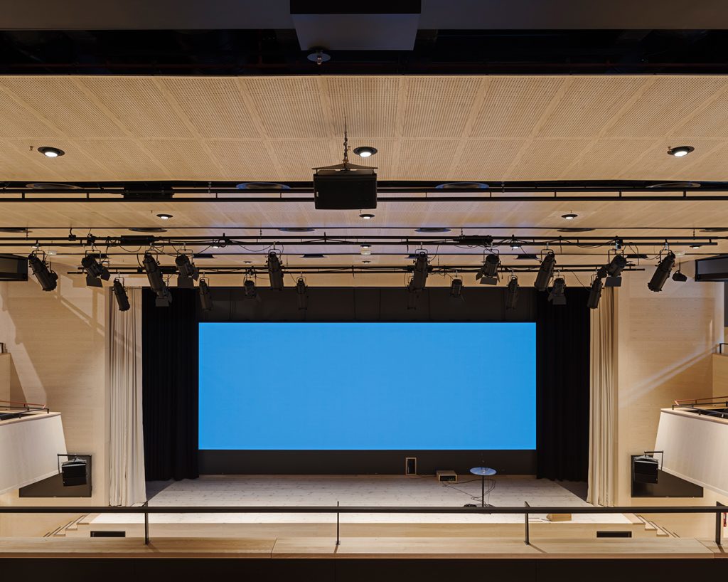 Stage view of auditorium with acoustic wood panels