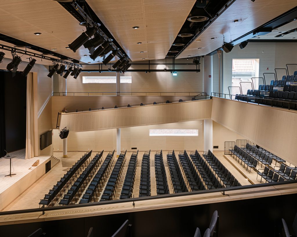 Auditorium clad with creative designed acoustic panels