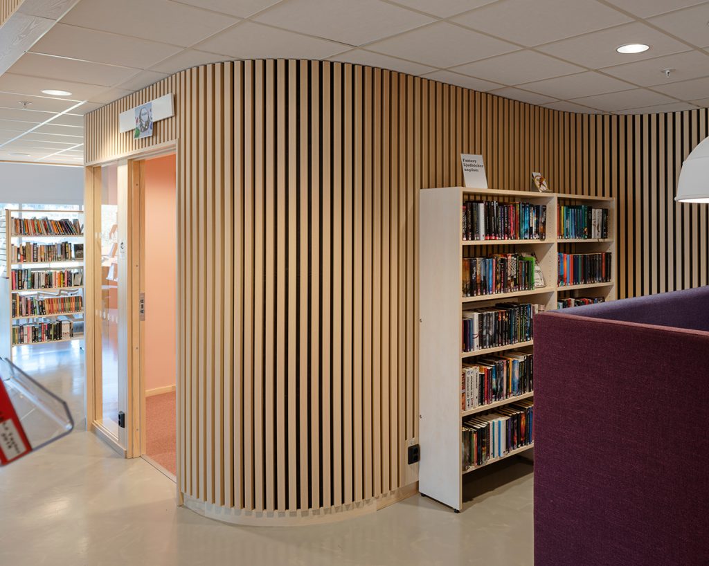 Curved wood slats on wall in public library