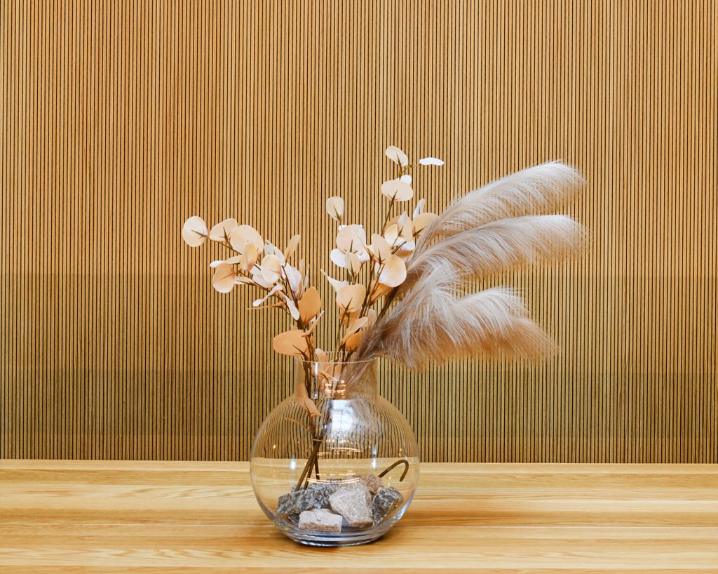 vase with flowers with wooden panel in the background