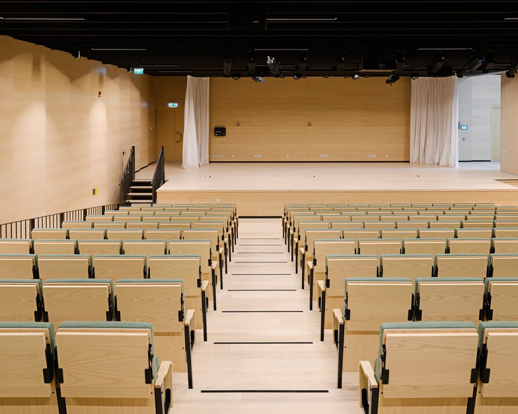 Auditorium with sound absorbing wood panels