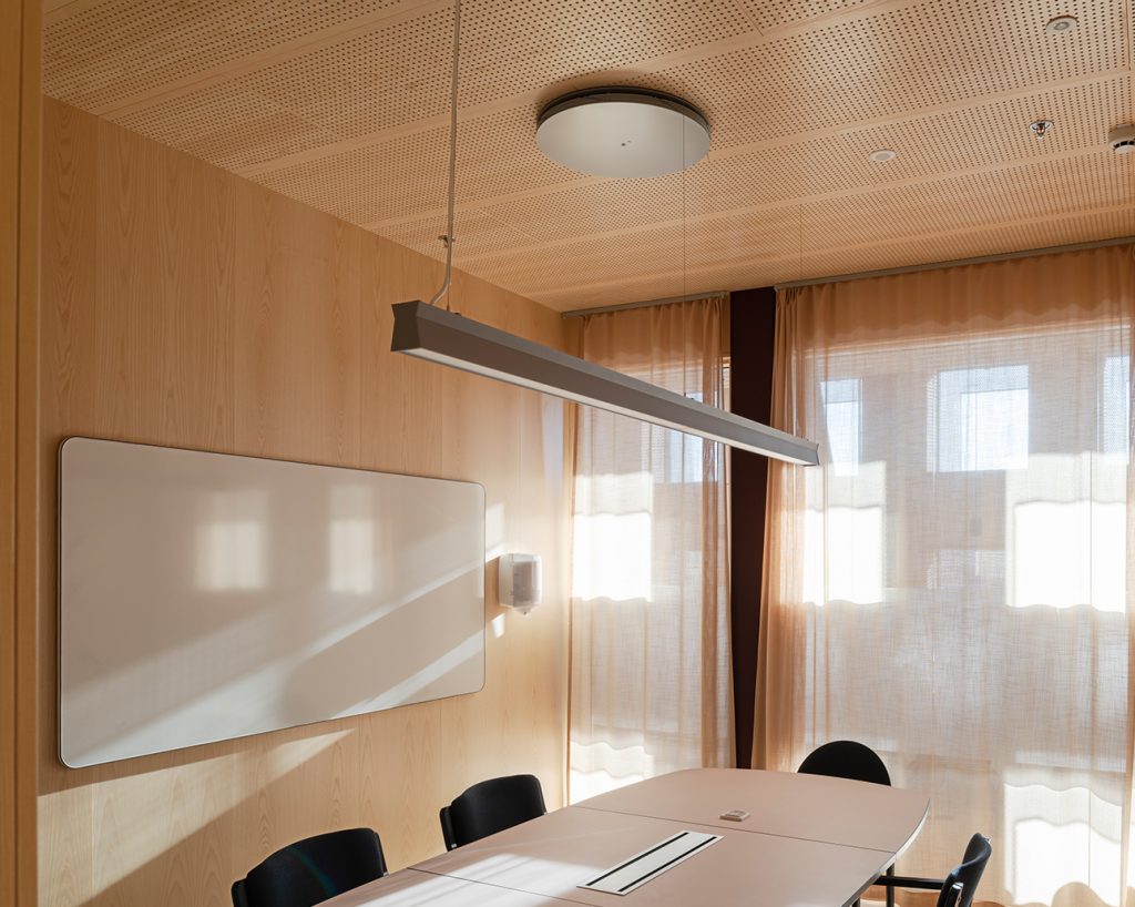 Inside university study room clad with ash veneered wall and ceiling panels