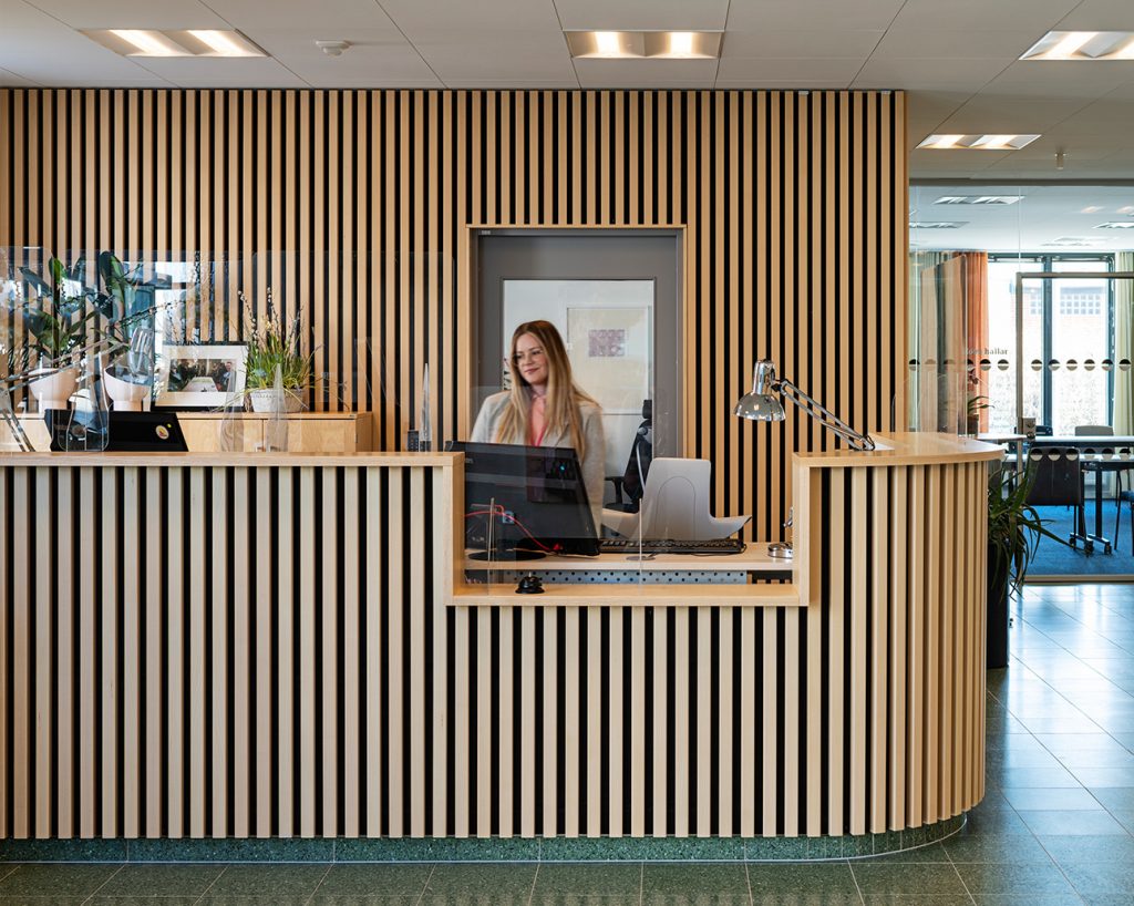 Office reception clad with wooden slats
