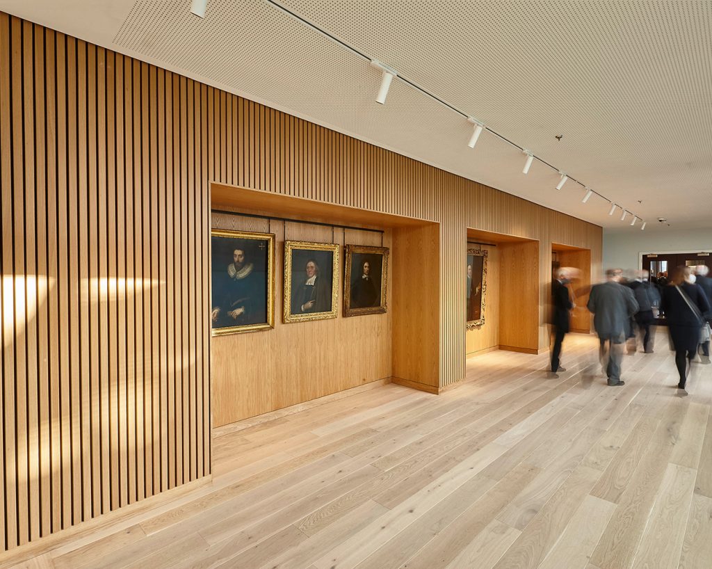 University interior with wood slats and paintings