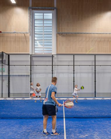 Kids lesson on padel court with acoustic panels on the wall