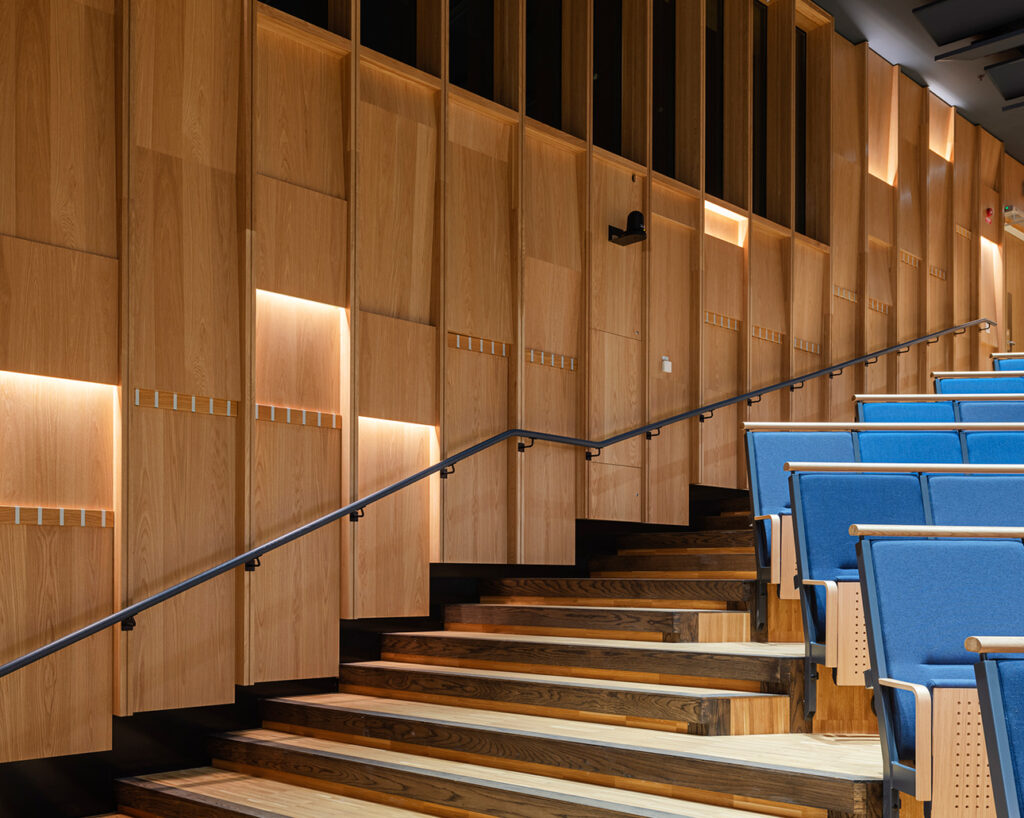 Panels with integrated lighting in auditorium