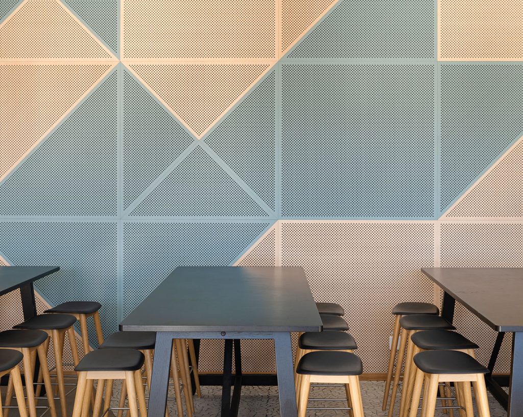 Acoustic panels on wall with tables in front