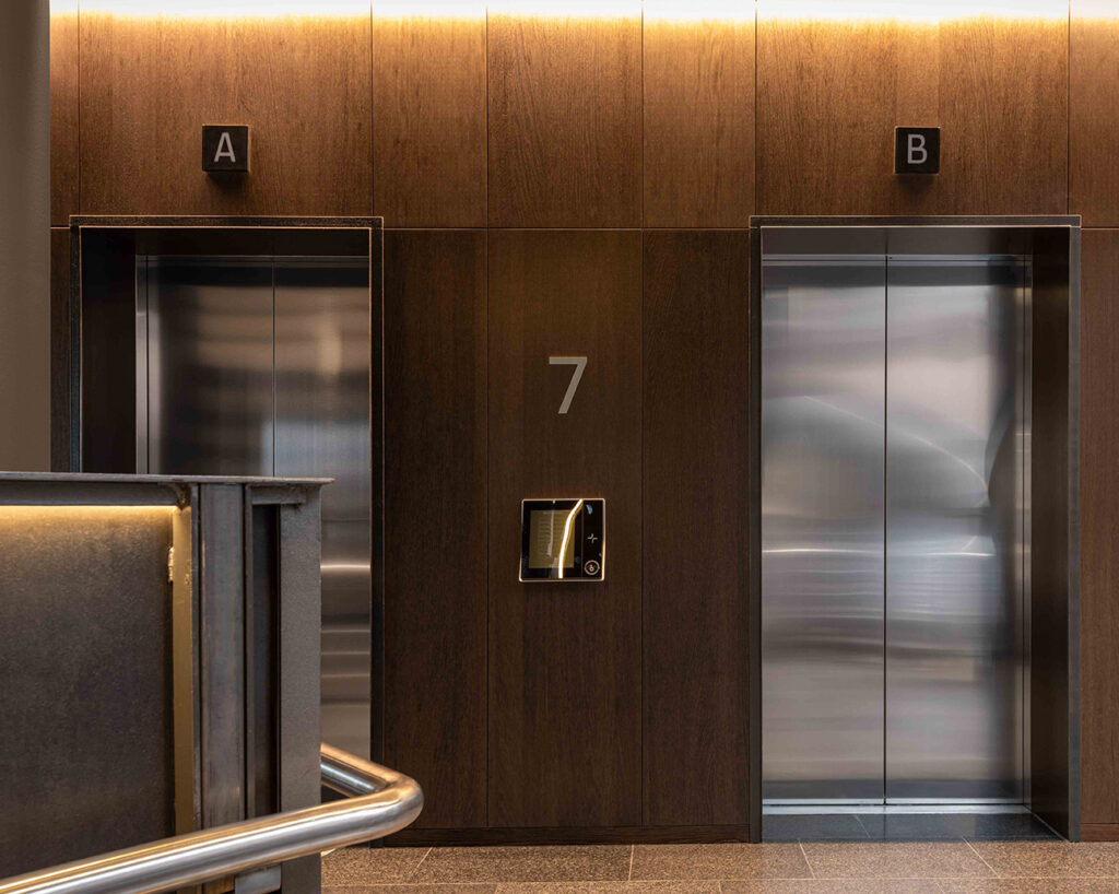 Wall panels by elevators