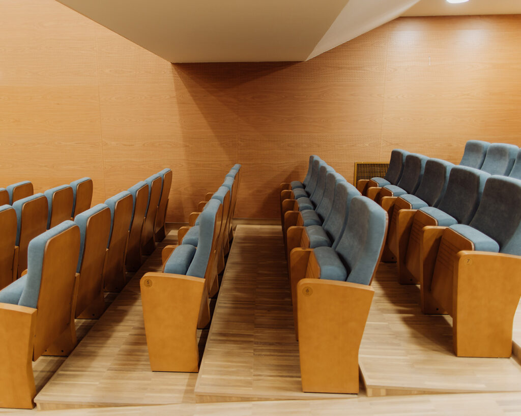 Cherry veneered wall behind seats