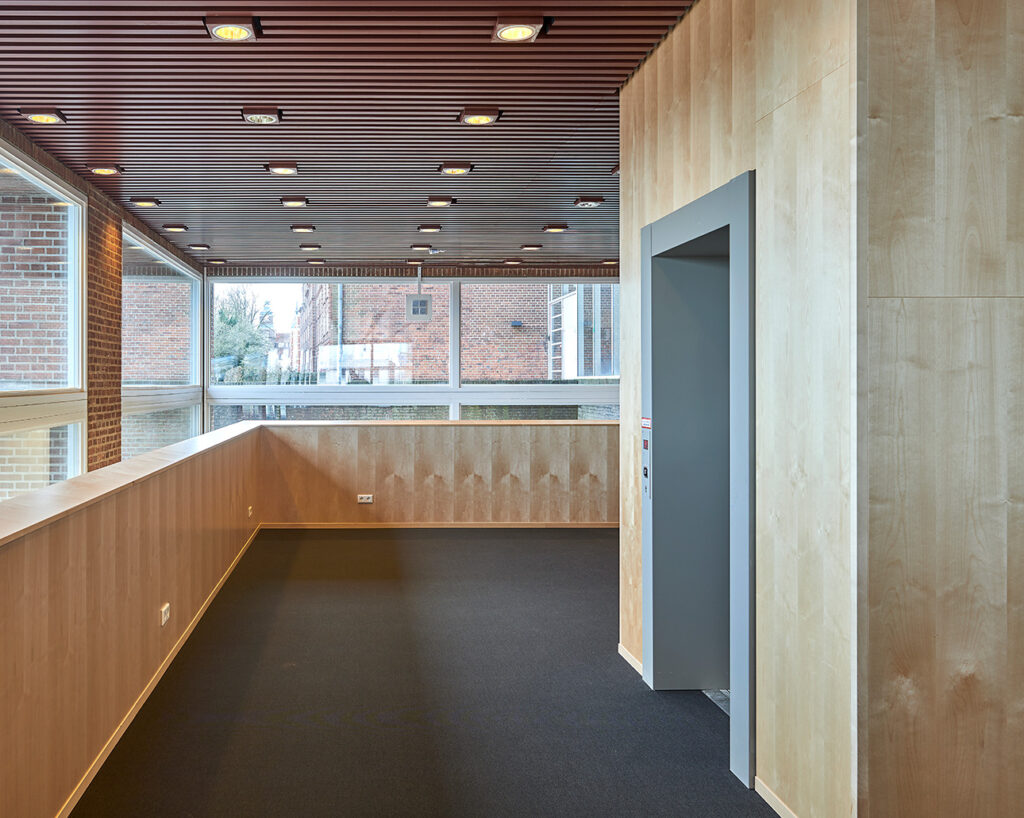 Wall panels by elevator and brick facade