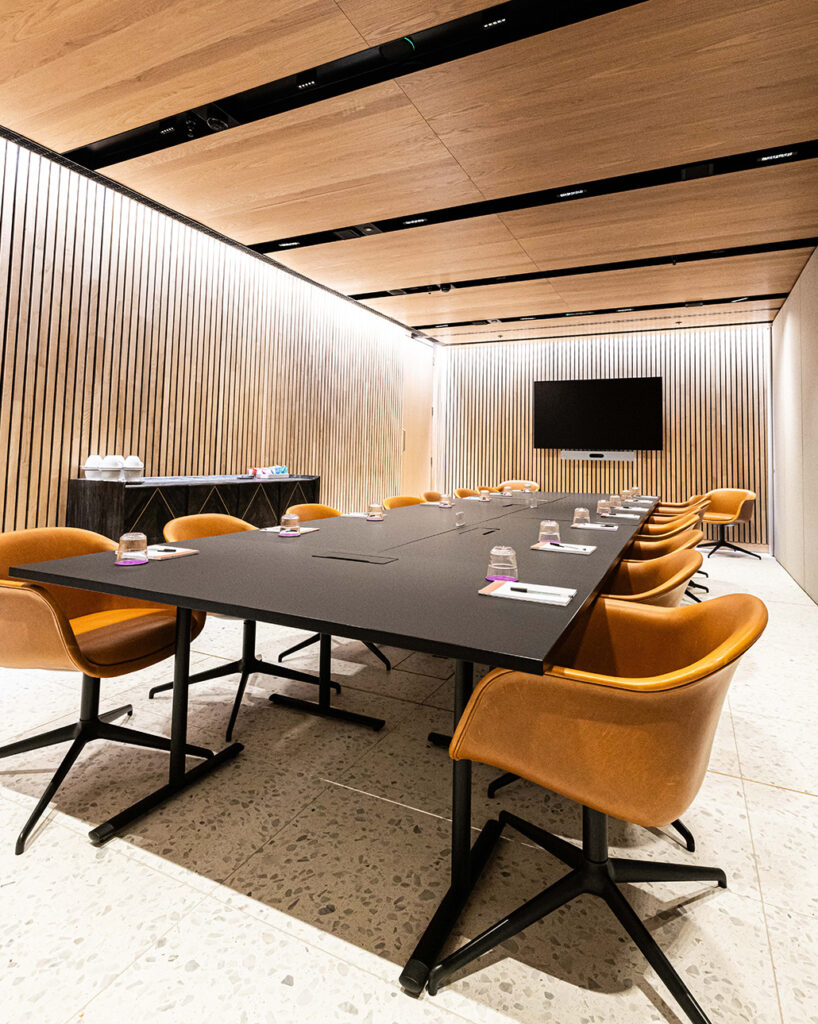 Panels in ceiling and Linear Ribs on walls in conference room