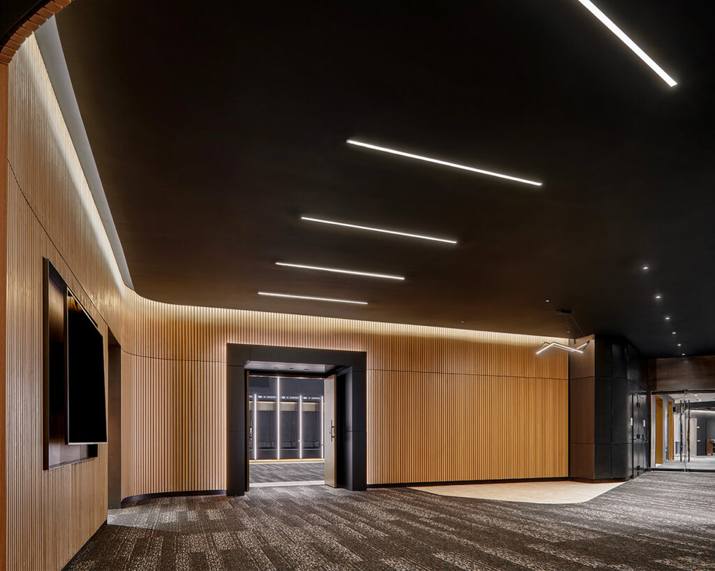 Linear ribs in oak veneer outside locker room